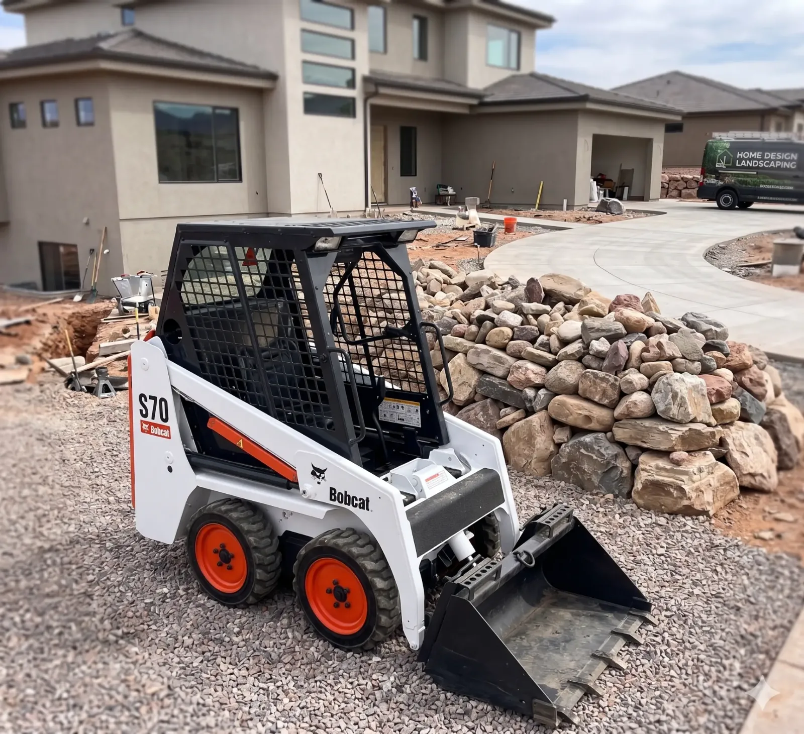 RockSpread AZ compact skid steer spreading landscape rock through a backyard gate